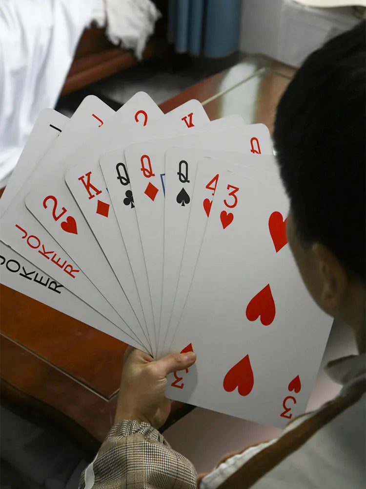 Set of oversized large size paper playing cards laid out on a table, showing the full 54-sheet deck.