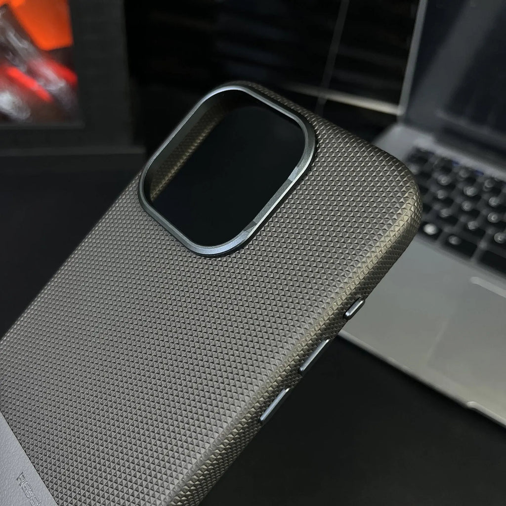 Black magnetic iPhone case with dragon scale texture and stitching, shown on an iPhone.