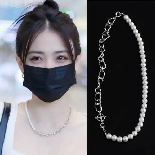White acrylic geometric asymmetric pendant on a twisted chain, a clavicle-length necklace.