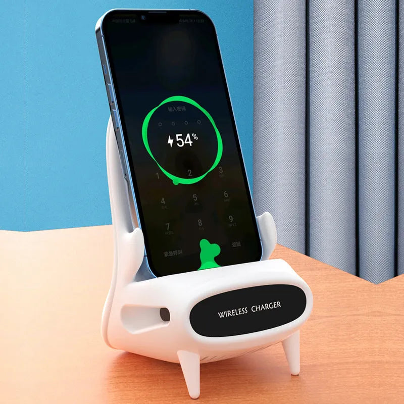 White chair-shaped wireless charging phone stand charging a smartphone on a desk