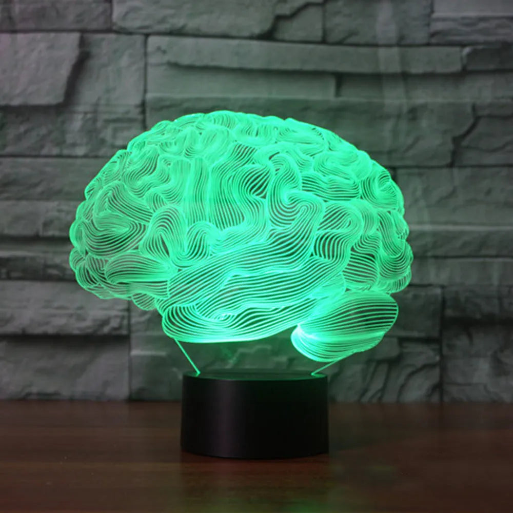 3D acrylic brain hologram LED desk lamp with black base and remote control on a wooden table.