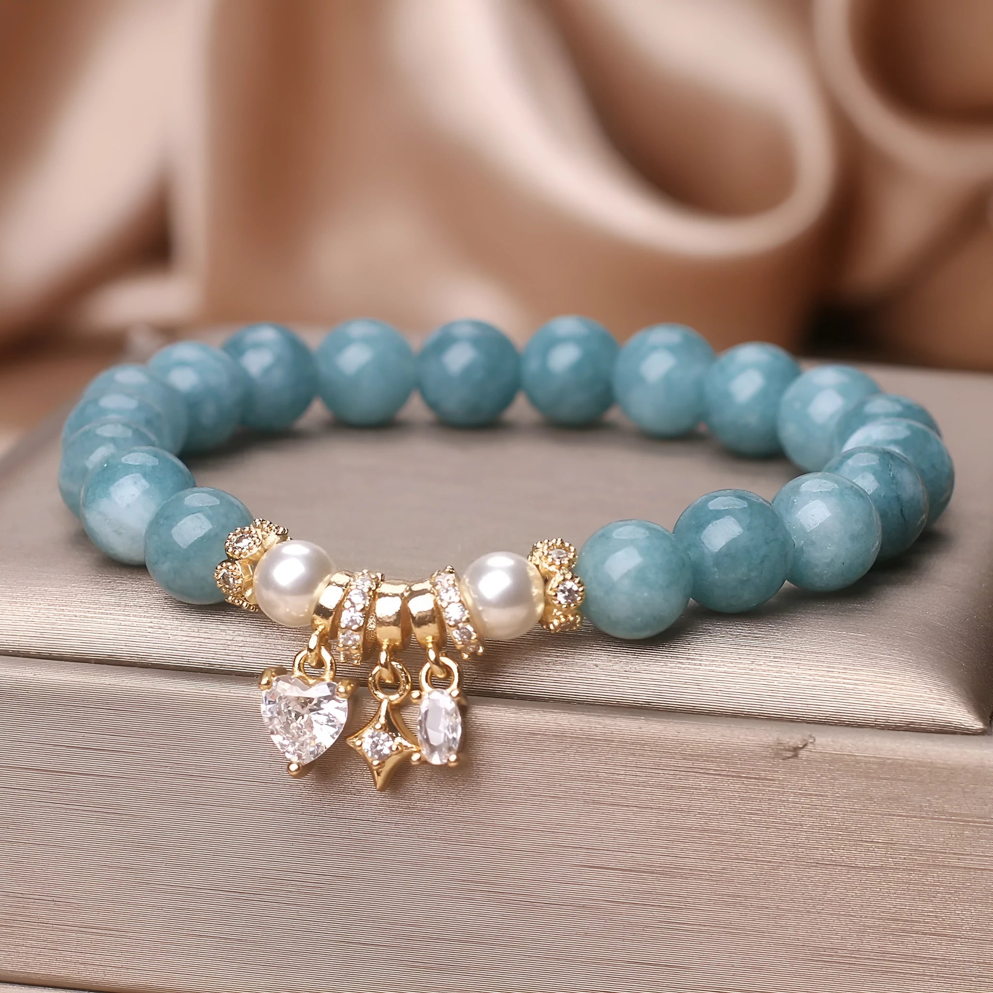 Blue water jade bracelet with heart-shaped zircon pendant and agate beads on display