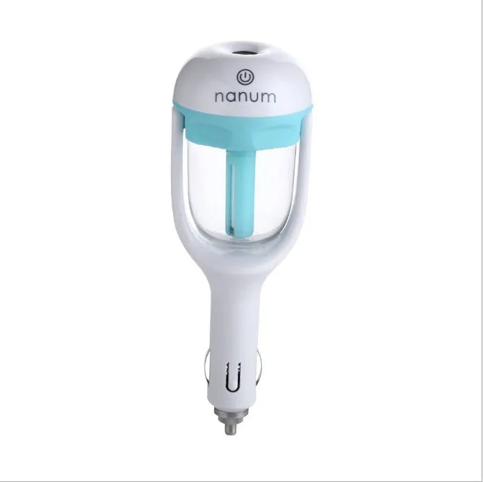 Compact blue portable car humidifier and essential oil diffuser with rotating nozzle on a car dashboard.