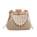 Women's straw woven shoulder bag with pearl chain strap showing interior organisation pockets