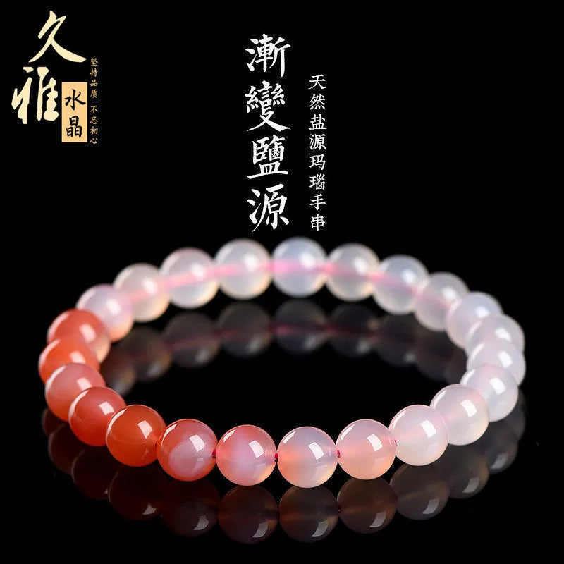 Natural gradient Yanyuan agate bracelet with geometric beads on a wrist, showing colour transition.