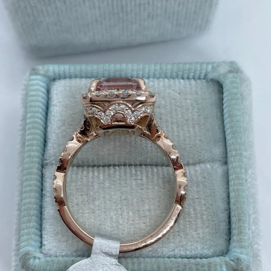 Rose gold geometric alloy ring on a plain background, showing its shape and electroplated finish.