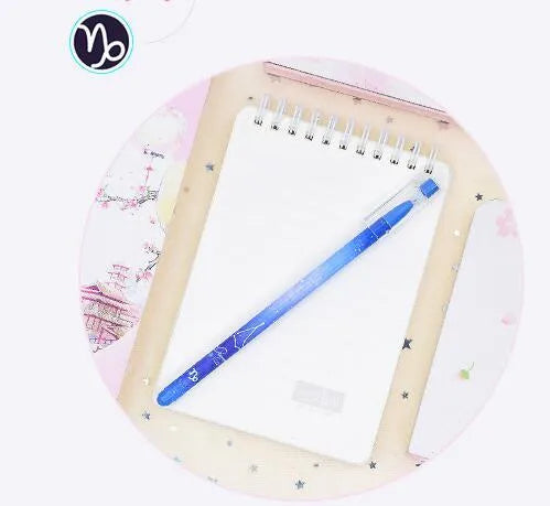 Box of 12 plastic gel pens with quick-drying ink and constellation-themed designs in assorted colours