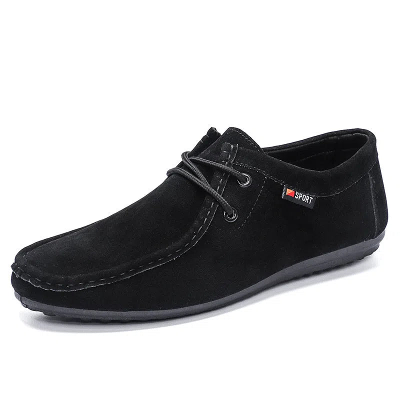 Men's black slip-on loafers with soft sole, round toe, and stitching detail on a neutral background