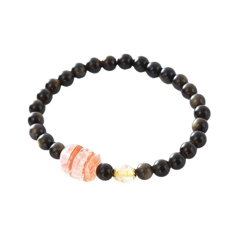 Handmade gold obsidian and red flower bead Pi Xiu bracelet on wrist, ethnic retro style.