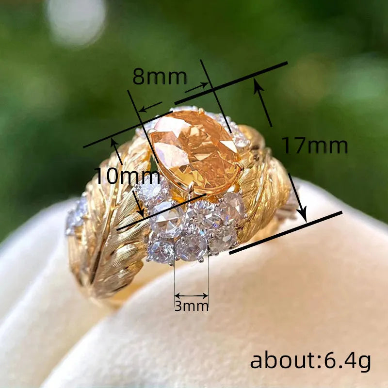 Women's gold-colour copper ring with embossed feather design and inlaid yellow zircon stones in geometric shape