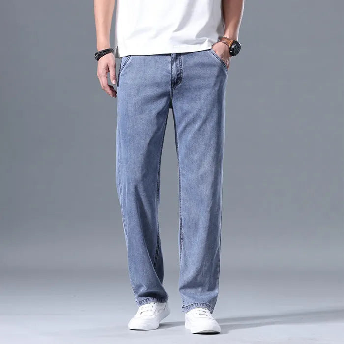 Man wearing light blue loose straight-leg lyocell jeans with a zipper fly.