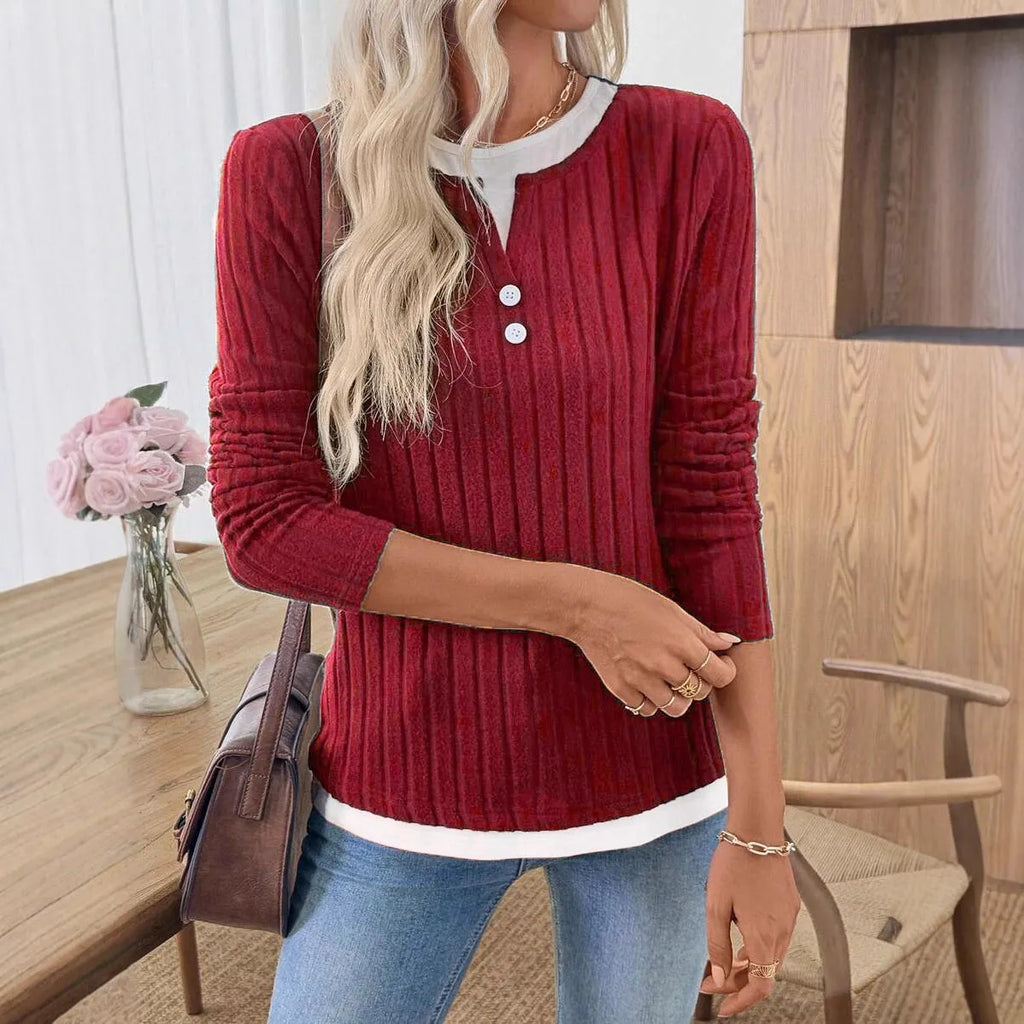 Women's black two-piece style pullover sweater with round neck and button detail on long sleeves.