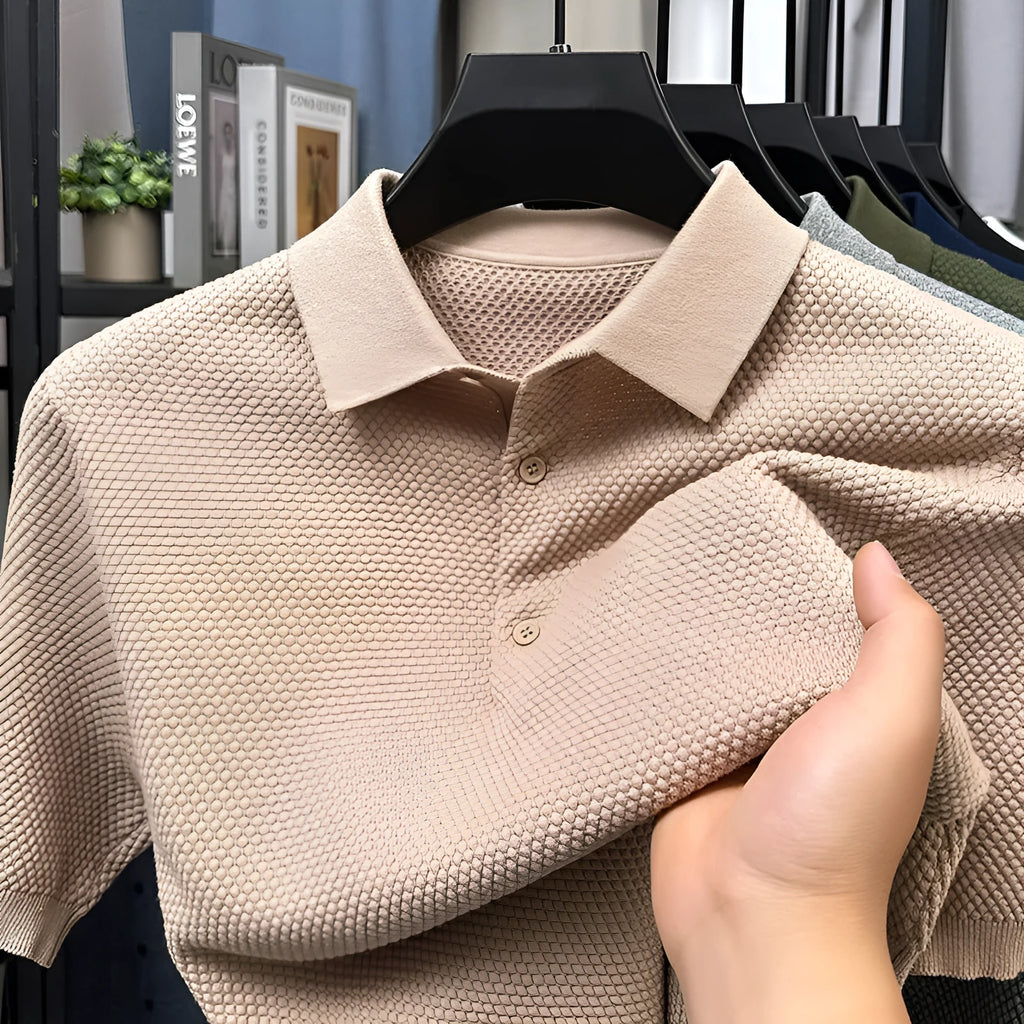 Man wearing a loose grey cotton short sleeve pullover sweater in a casual setting