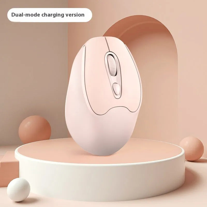 Bluetooth wireless mouse in choice of girl pink, milk tea pink, grey or green colours on a desk next to a laptop.