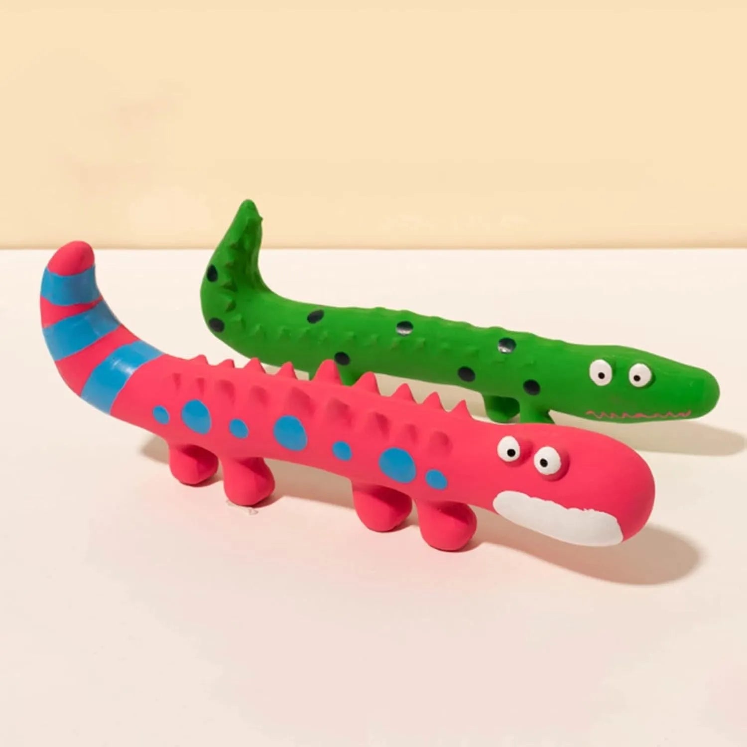 Green lizard-shaped dog chew toy with textured surface and squeaker for teeth cleaning