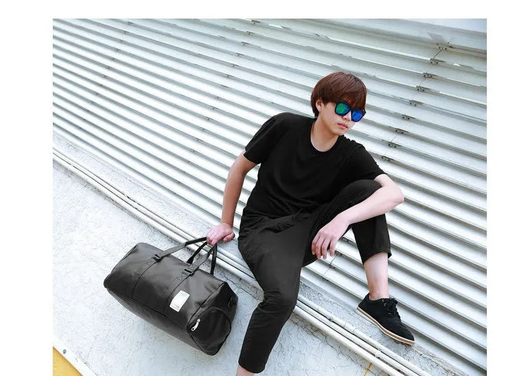 Black waterproof sports fitness bag with separate shoe compartments and diagonal carrying straps