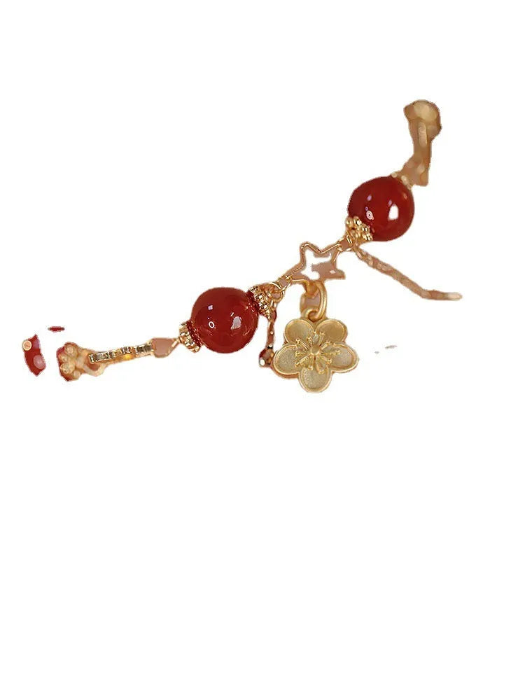 Women's double layer bracelet made from natural red agate with peach blossom decorations.