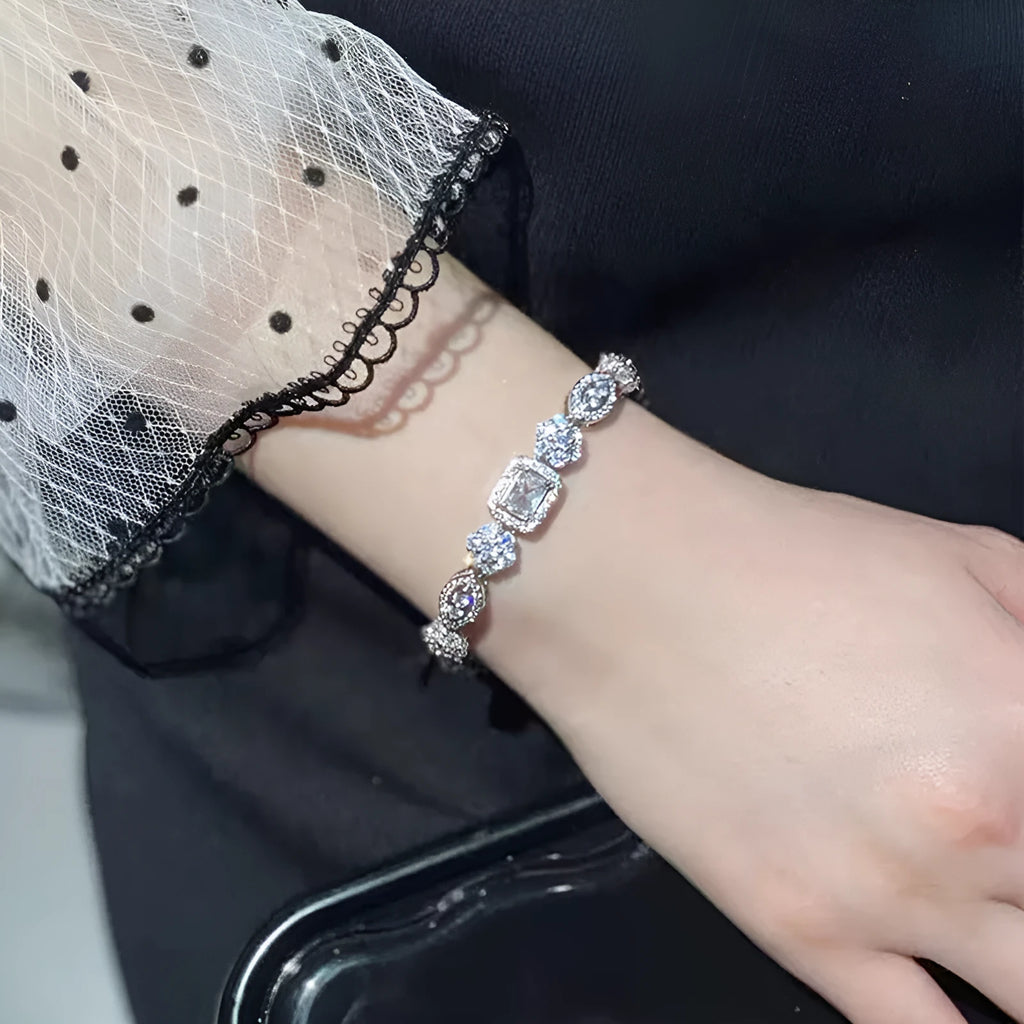 Women's geometric zircon bracelet with silver and white gold plating showing chain length options
