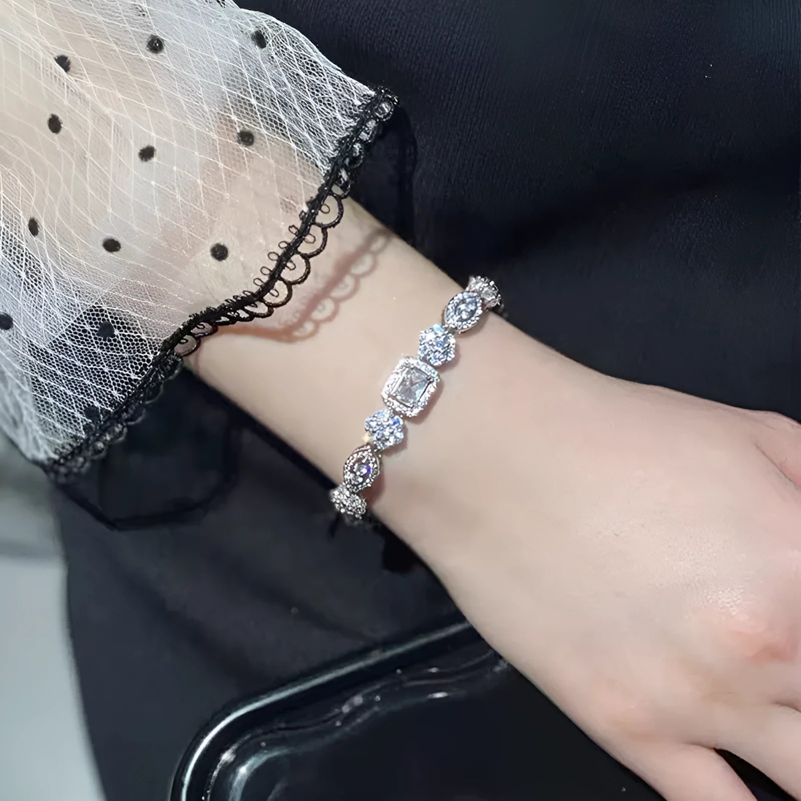 Women's geometric zircon bracelet with silver and white gold plating showing chain length options