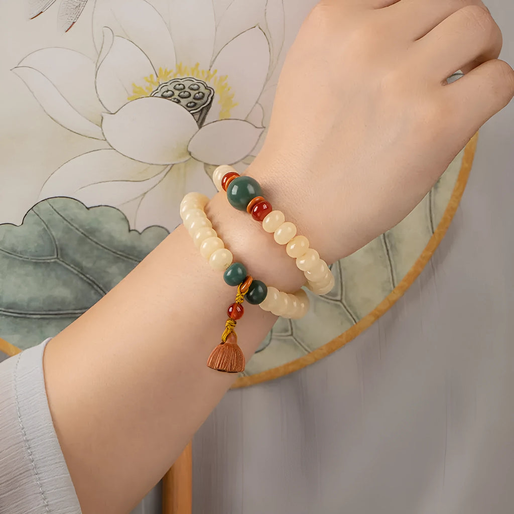 Milk butter coloured Bodhi root wood bracelet with 6x9mm flat round beads on wrist