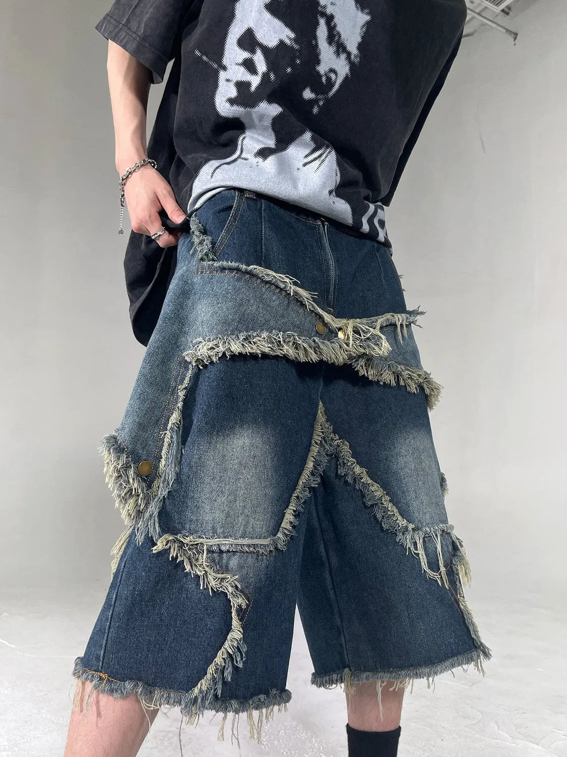 Blue denim shorts with frayed five-point star detailing in retro American style, loose fit for summer
