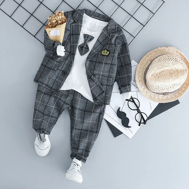 Grey cotton three-piece suit for a toddler boy on a hanger.