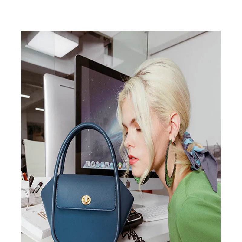 Wing shape cow leather cross-body handbag with buckle detail and fabric lining