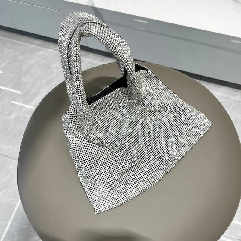 Silver ladies handbag with rhinestone embellishment on cotton thread construction and open outer pocket