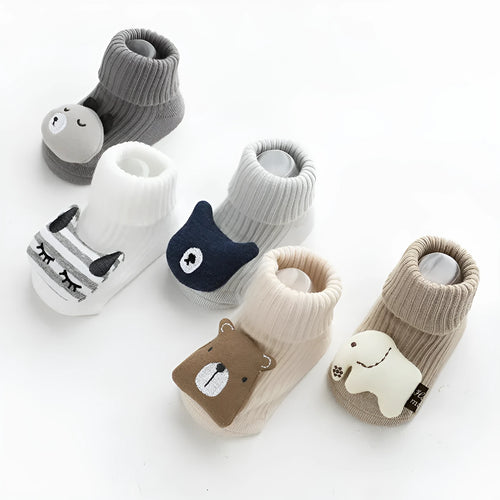 Baby socks with non-slip rubber grip soles on the feet, shown in a light grey colour.