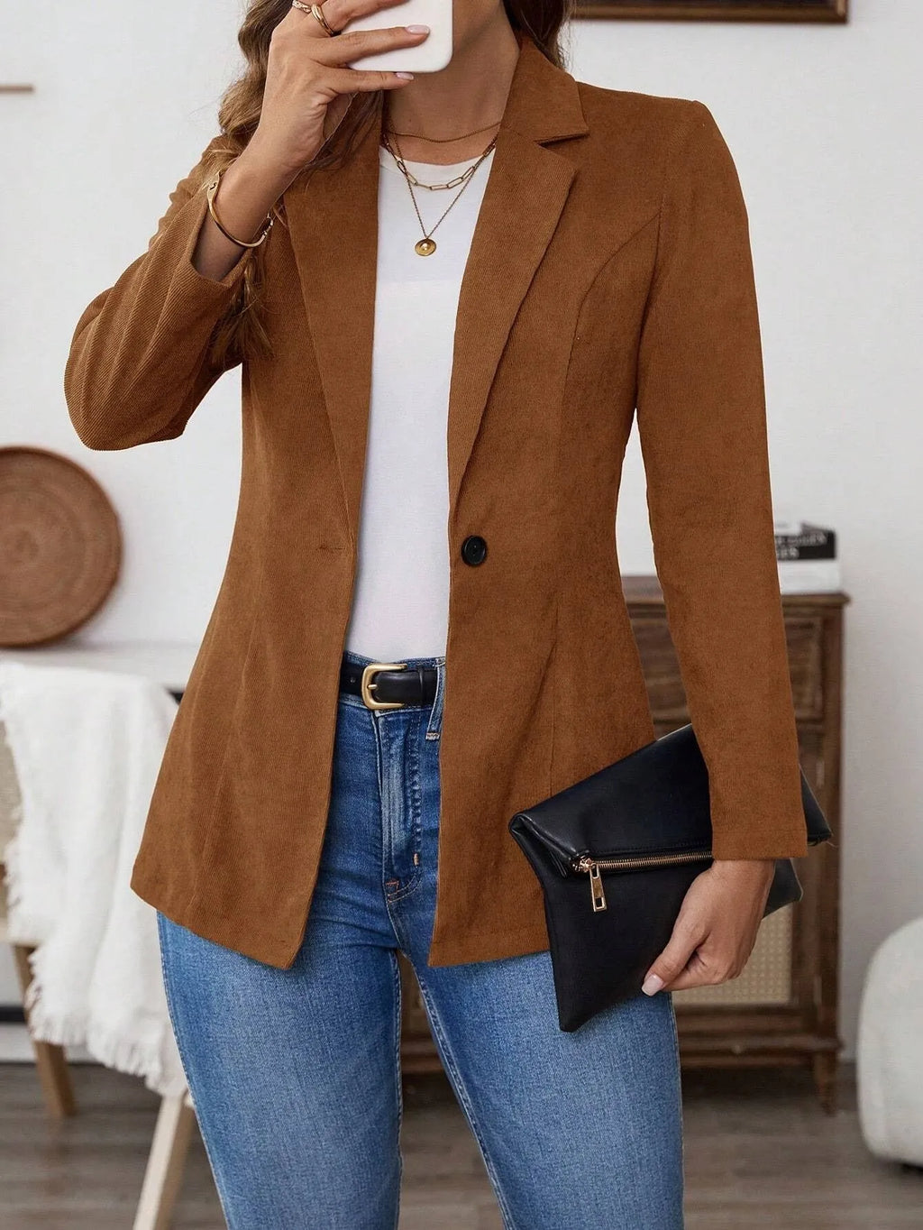 Brown single-breasted lapel leisure suit coat with long sleeves on a hanger