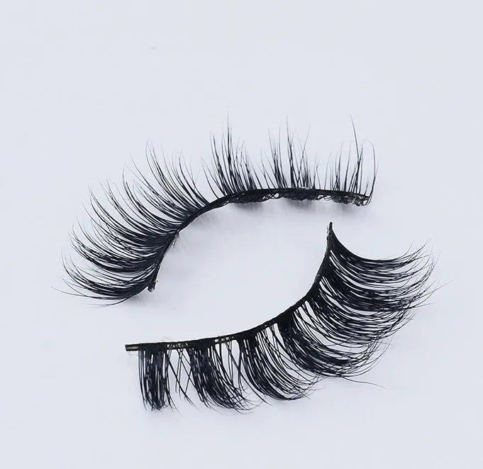 Pair of faux mink eyelashes with long tail and cotton stem against white background