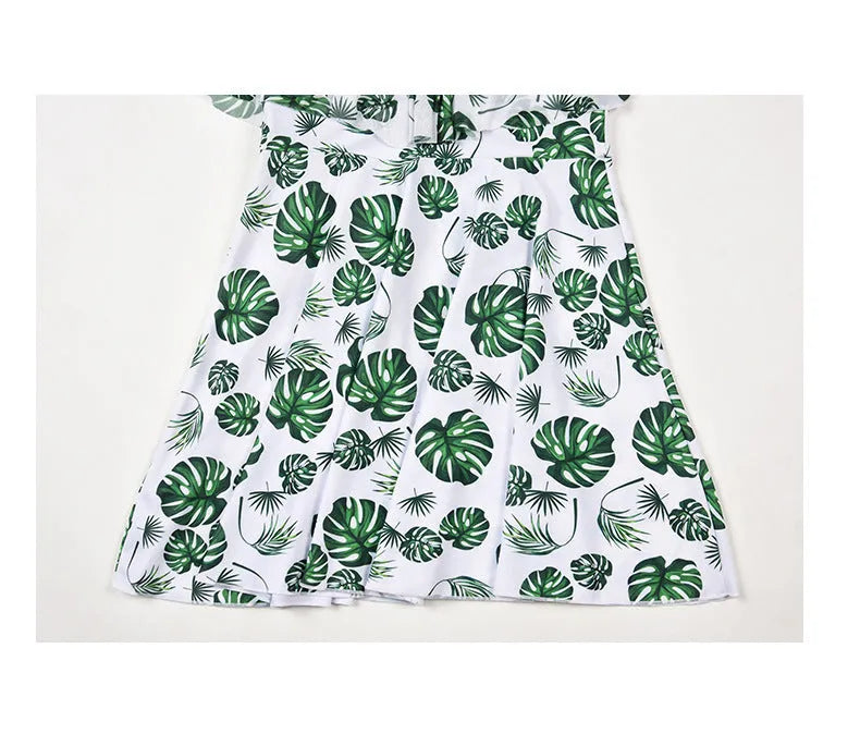 Women's green leaf style printed one-piece swimsuit laid flat.