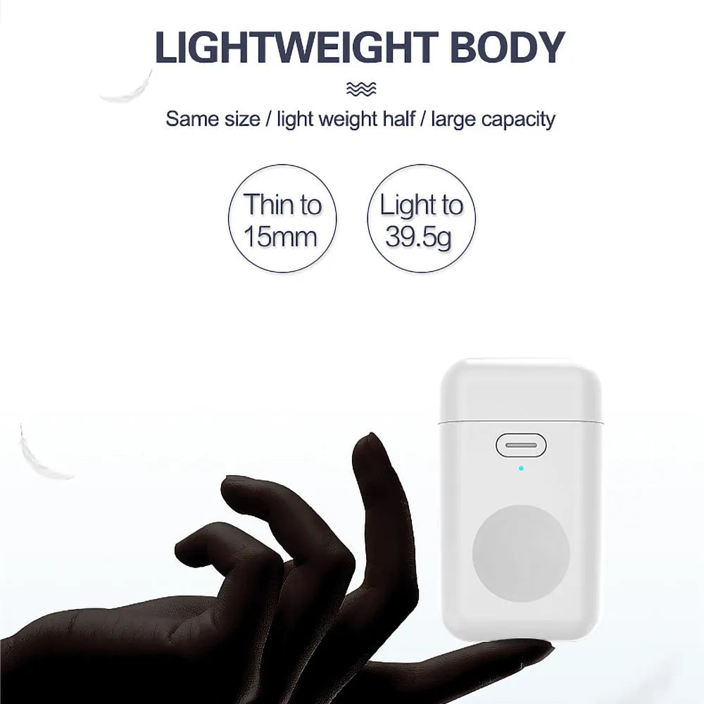 White mini magnetic portable charger for Apple Watch next to an Apple Watch on a table.