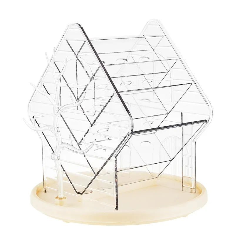 Rotating clear plastic cosmetics storage box with tiered compartments for brushes and bottles.
