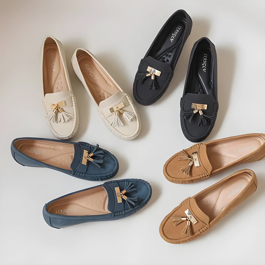 A pair of nude-coloured height-increasing shoe insoles with a round toe and a raised heel section.