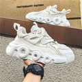 Men's black mesh sneakers with thick rubber sole, round toe, lace-up front, and abstract pattern