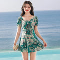 Women's solid colour one-piece polyester swimsuit in blue with flat-angle conservative cut