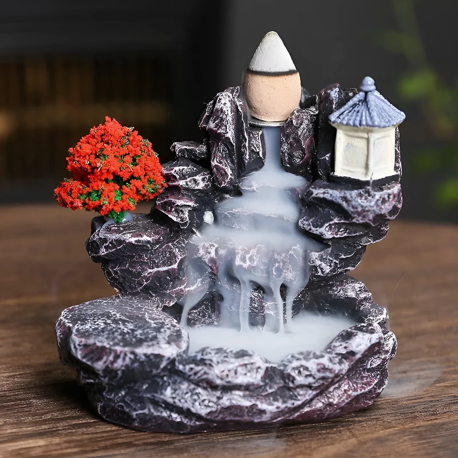 Ceramic backflow incense burner ornament in modern tree design on a table.