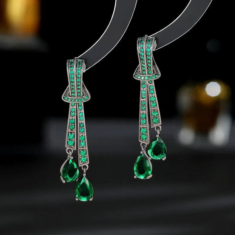 Knot drop earrings with silver needle post and zircon inlay in copper with electroplated finish, gold pearl colour