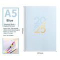 A5 daily planner notebook with soft faux leather cover in blue, lying open on a table.
