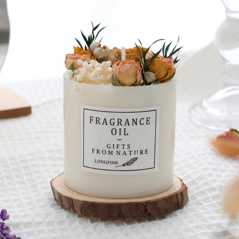 Aromatherapy candle with dried flowers on surface, shown in gift box with chip base.