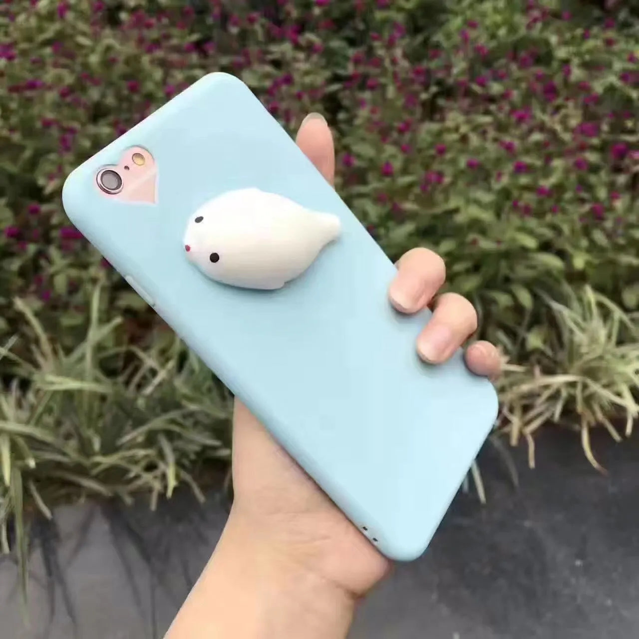 Soft pink silicone iPhone case with a 3D cartoon cat design on the back.
