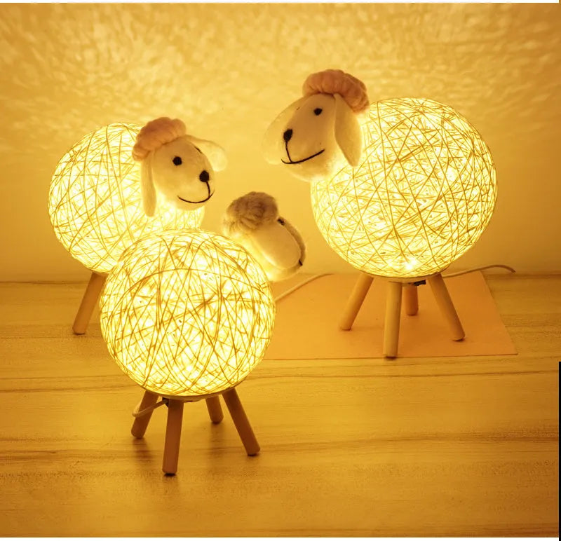 Hand-woven beige lamb night light with starry sky projection on a bedside table