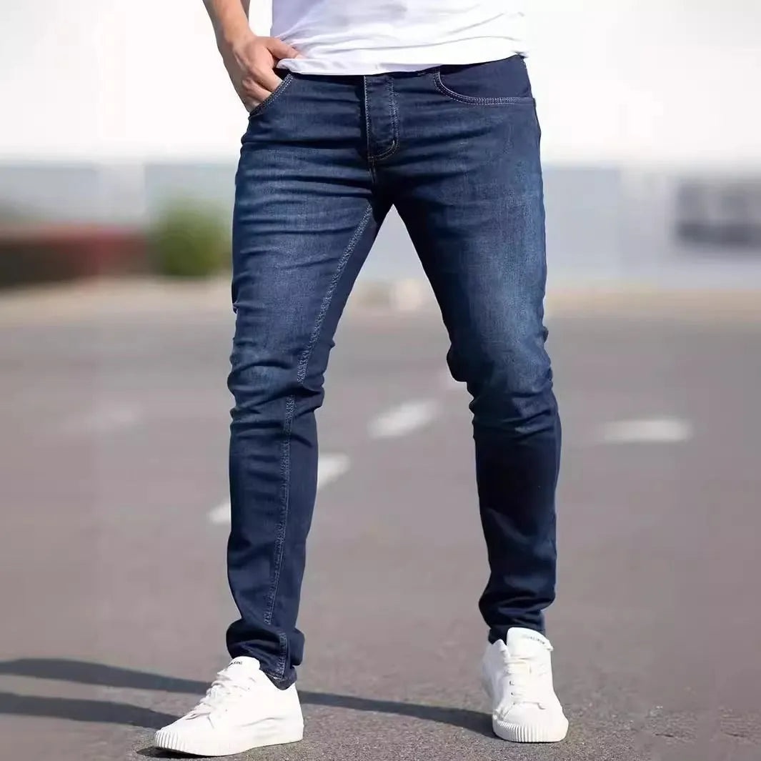 A man wearing dark blue slim fit casual jeans with an elastic waistband.