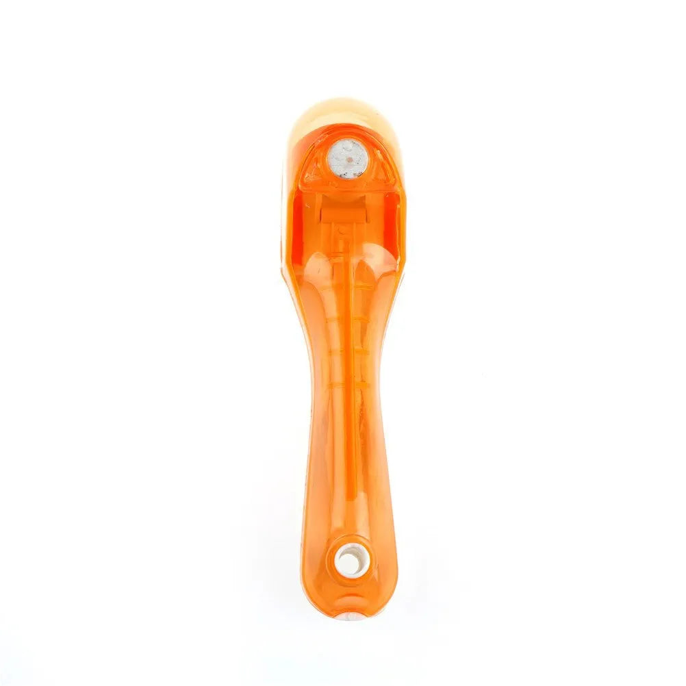 Two magnetically nested digital measuring spoons in blue and orange on a kitchen surface