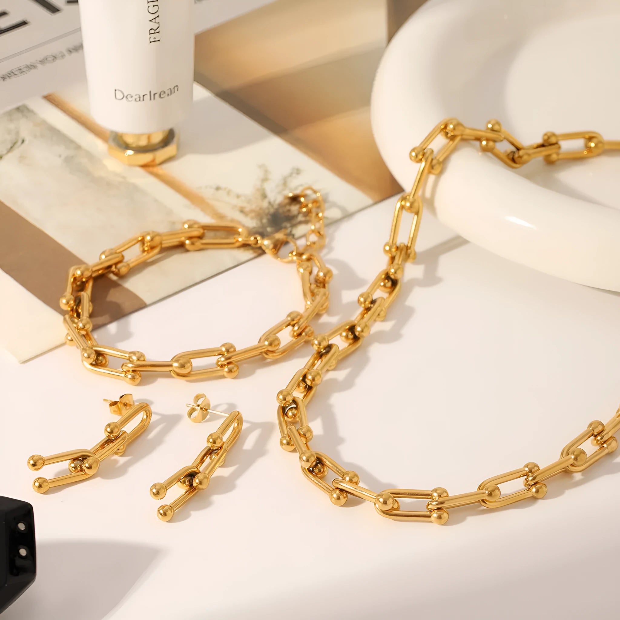 Stainless steel horseshoe charm jewellery set showing necklace, bracelet, and earrings with titanium steel pendants on a regular chain.