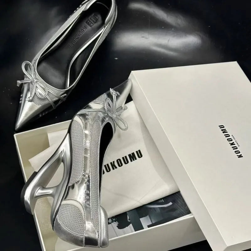 Women's black pointed toe Mary Jane shoes with a distinctive shaped floating heel and slip-on design.