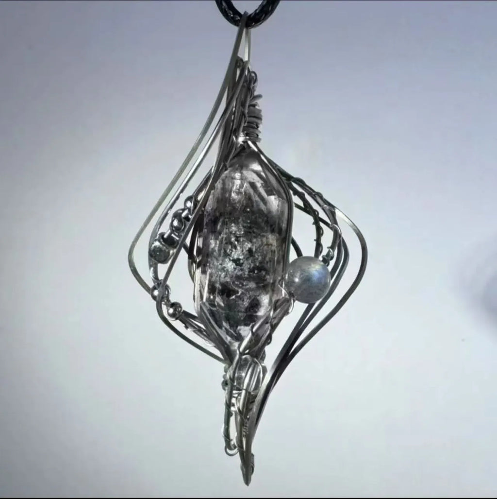 Hollow out Mori style winding pendant on an adjustable alloy cross chain necklace.