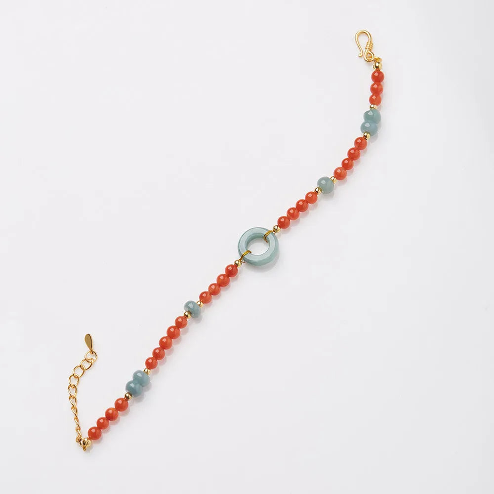 A woman's adjustable South Red Agate bracelet with 4mm beads and a safety buckle on a wrist.