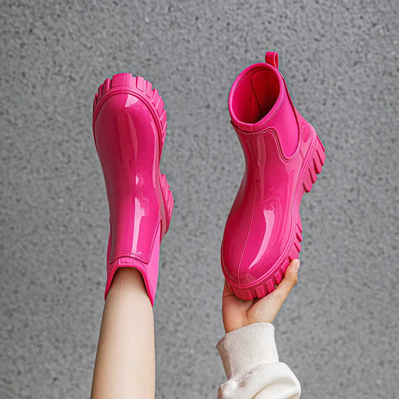 A pair of low tube PVC rain boots with a flat heel, shown in a solid colour on a white background.